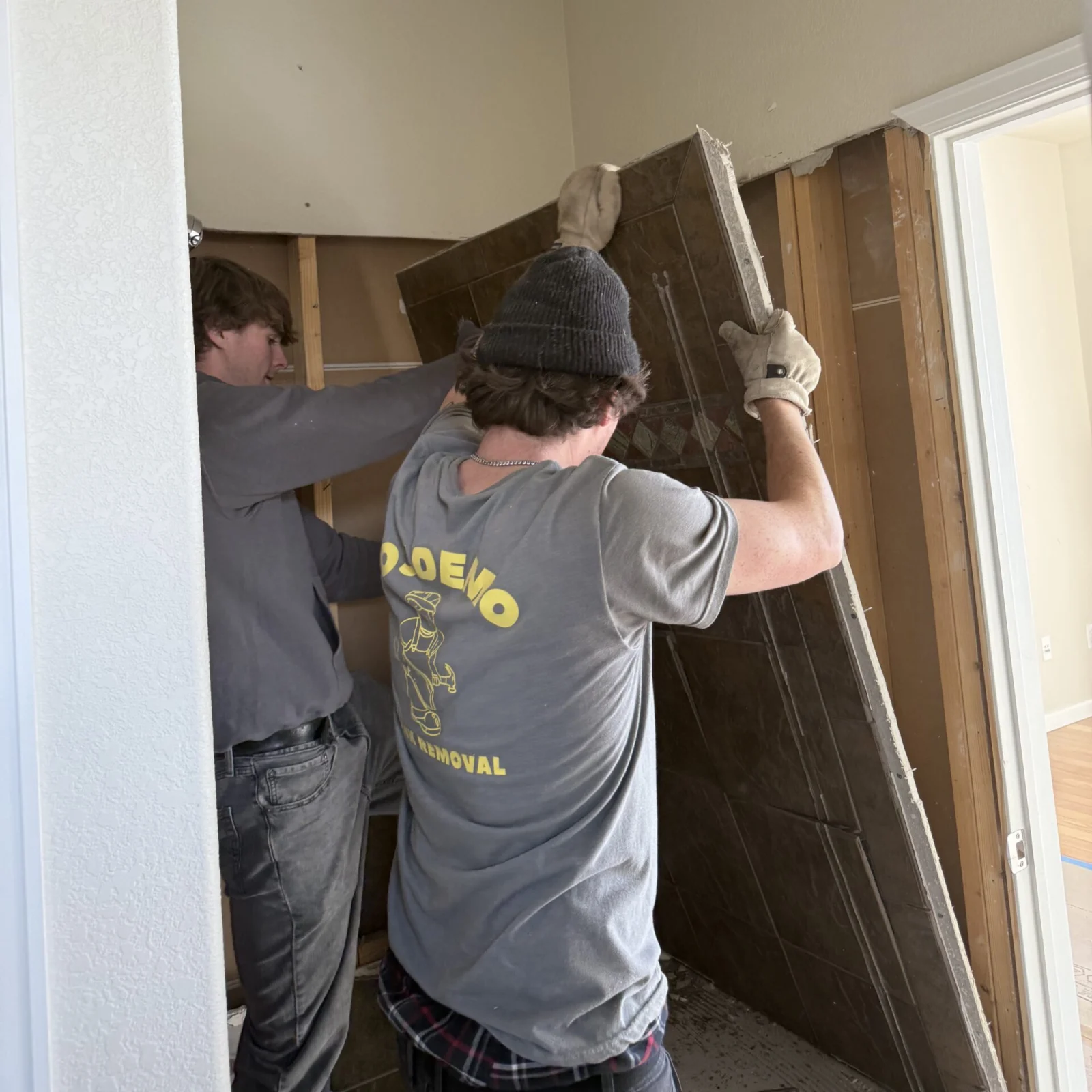 2 guys taking down a door