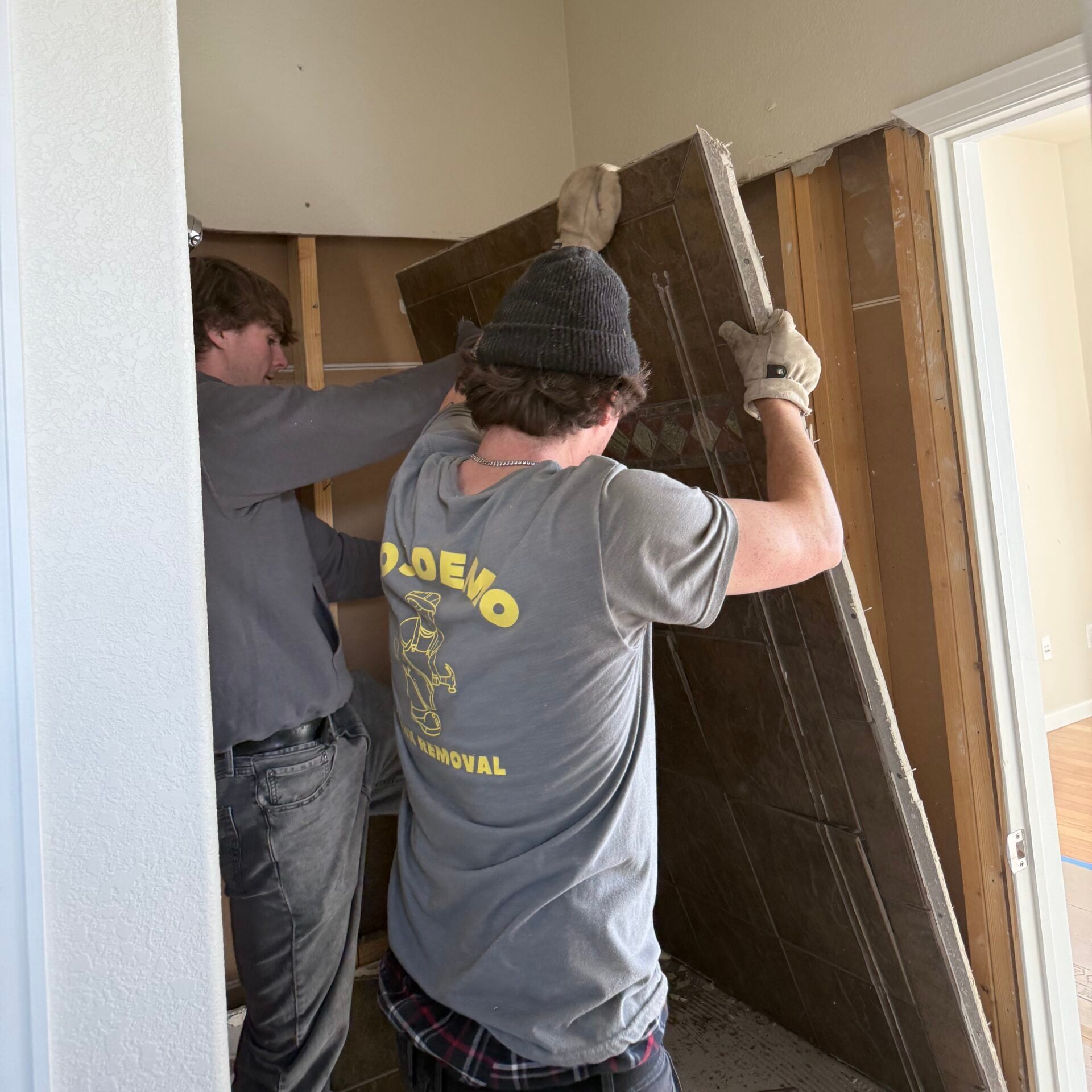 2 guys taking down a door